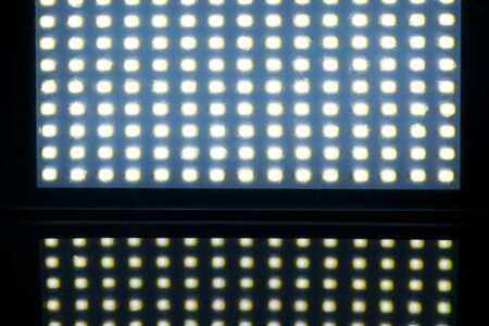 Many LED lights covered with scratched transparent matte filter reflect the light on black background with copy spaceの写真素材