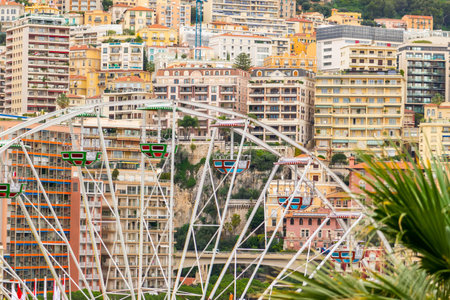 White ferris wheel in the  of Monaco city buildings
