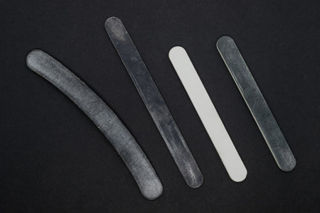 Various type and shape used manicure nail buffs on matte black