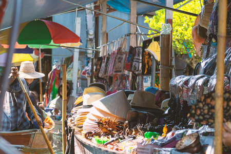 Thailand Bangkok 4 MAR 2020 Travel and leisure concept. Salesman selling goods in floating market. Vintage tone filter color style. Hats is in camera focusのeditorial素材