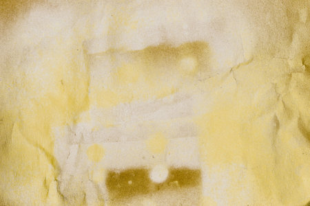 Grunge texture background of beige craft paper with silver, golden and white aerosol paints on itの写真素材