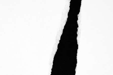 White ripped paper isolated on black background with copy spaceの写真素材