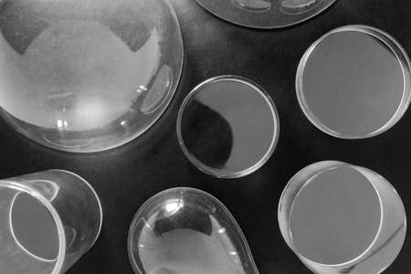 Top view of various shapes plastic bowls covered with dust on black matte backgroundの写真素材