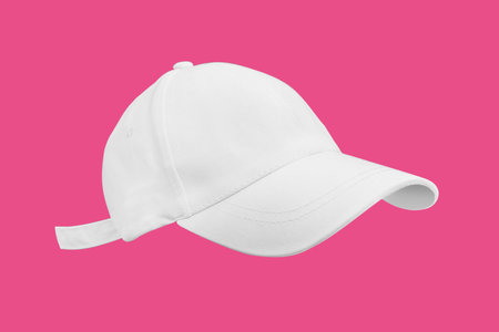 Profile view of white sport cap mockup with copy space isolated on pink backgroundの写真素材