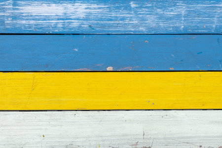 Abstract background of colored in blue, yellow and white paint old and grunge wooden planks with copy spaceの写真素材