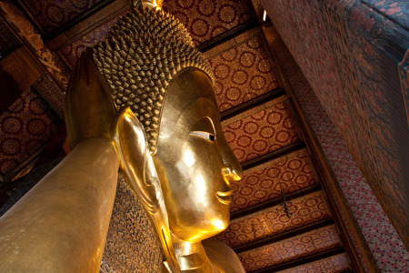 Golden buddha face in half view of Bangkok, Thailandのeditorial素材