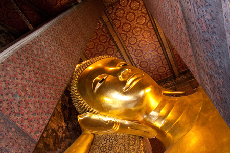 Face of golden buddha in templeの写真素材