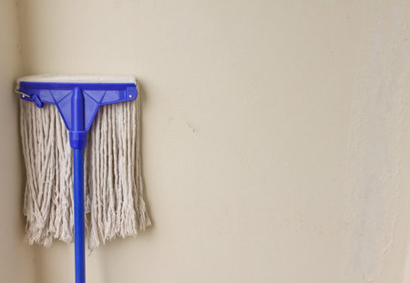 Mop on the wall background