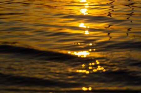 Beautiful sunset over the river. The solar path on the surface of the water. Reflection of the setting sun.の写真素材