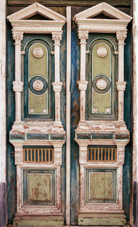 An old wooden colorful front door to house. Outdoors. Close-upの写真素材