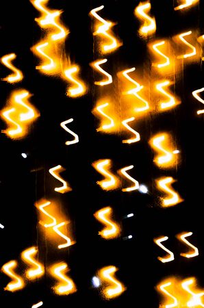 Festive abstract textured background. Yellow lights on black. Christmas lights.の写真素材