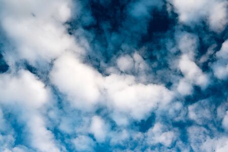 Blue dramatic sky background with white clouds. Beautiful cloud scape. Cumulus cloudsの写真素材