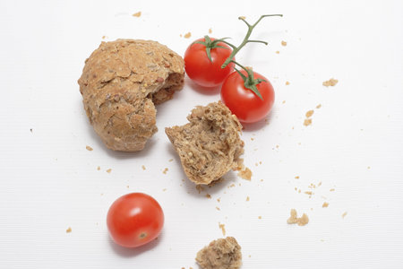 Red tomato and a lot of crumbs of bread