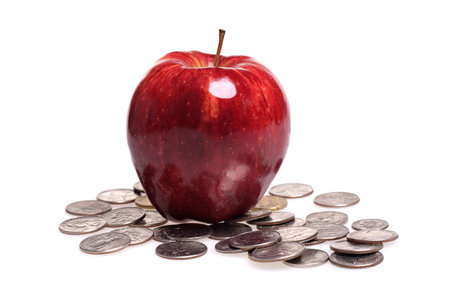 Red apple and coins isolated on a white background