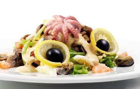 Seafood Salad Comprises Shrimps and Octopus Meat Dressed with Olives and Lemon Slice. Isolated on White Backgroundの写真素材