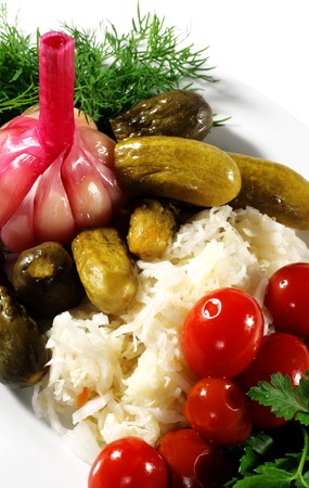 Pickled Vegetables Plate (tomatoes, cucumbers...) Served with Dill and Parsley. Isolated on White Backgroundの写真素材