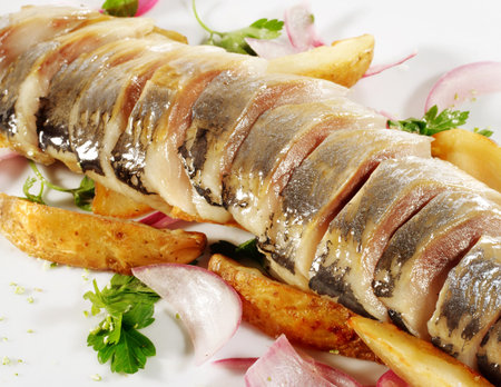 Sliced Fish Served with Baked Potatoes, Green and Onion.