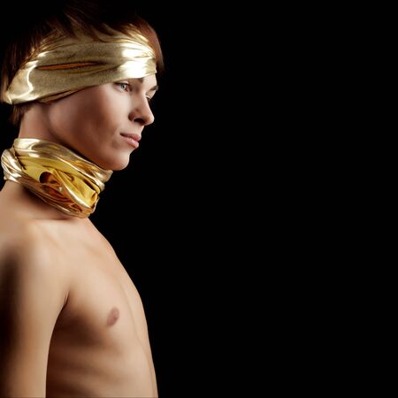 Glamour Man with Gold Bandage. Isolated on Black Backgroundの写真素材