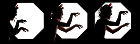 Silhouette of Steal Up Devil with Red Horns. Isolated on Black Backgroundの写真素材