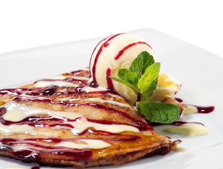 Pancakes with Orange Sauce and Ice Cream with Fresh Mint Leaves. Isolated on White Backgroundの写真素材