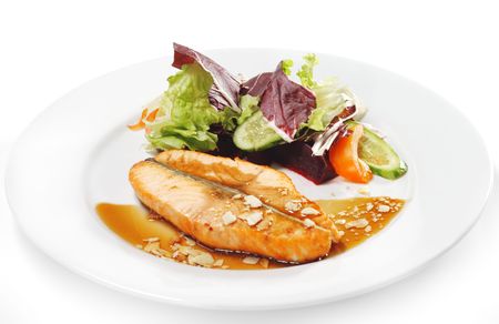 Hot Fish Dishes - Salmon Steak with Narsharab Sauce and Fresh Salad Leaves. Isolated on White Backgroundの写真素材