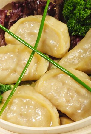 Japanese Cuisine - Pork Dumplings in Bast Basket with Salad Leafの写真素材
