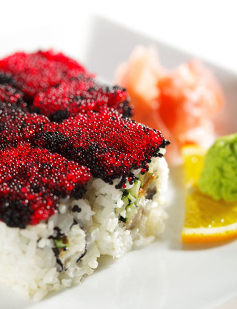 Night City Maki Sushi - Roll made of Cream Cheese, Tamago (japanese omelet), Cucumber and Smoked Eel inside. Tobiko (flying fish roe) outsideの写真素材