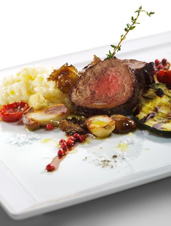 Prime Veal with Risotto, Tartufo Nero (Black Truffle), Zucchini Grill, Porcini and Dried Tomatoの写真素材