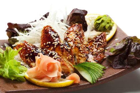Unagi Sashimi - Smoked Eel on Daikon (White Radish) with Eel Sauce and Sesame. Garnished with Ginger, Wasabi, Seaweed, Cucumber, Salad Leaf and Lemonの写真素材
