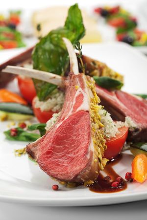 Roasted Lamb Chops with Pistachio. Garnished with Vegetables and Basilの写真素材