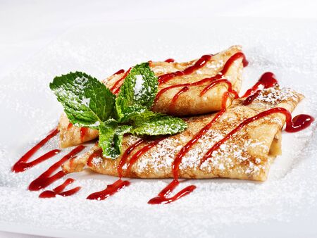 Pancakes with Berries Syrup, Fresh Mint and Powdered Sugarの写真素材