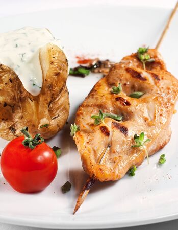 Chicken Breasts Shish Kebab Served with Roast Potatoes and Cherry Tomatoの写真素材