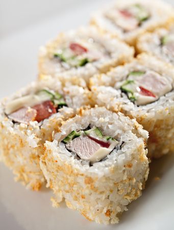 Caesar Maki Sushi - Roll made of Smoked Chicken Breast, Cheese, Tomato and Cucumber inside. Croutons outsideの写真素材