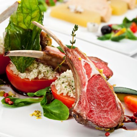 Roasted Lamb Chops with Pistachio. Garnished with Vegetables and Basilの写真素材