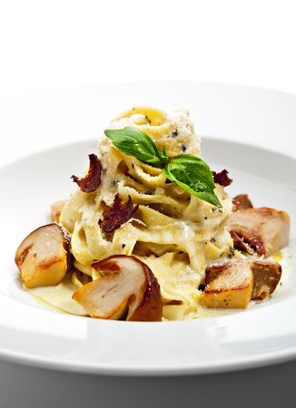 Tagliatelle with Mushroom, Cream Sauce, Truffle and Basil Leafの写真素材