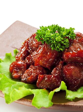 Japanese Cuisine - Beef with Sweet Pepper Deep Fried in  Sour-Sweet Sauce. Garnished on Salad Leaf, Topped with Parsleyの写真素材