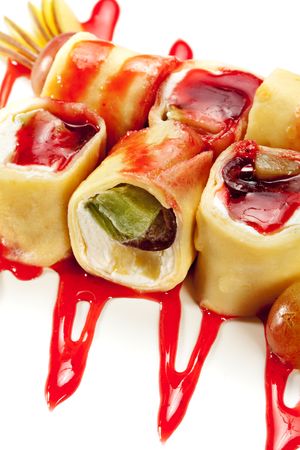 Dessert Maki Sushi - Roll with Various Fruit and Cream Cheese inside. Pancake outside. Served with Pear, Grapes and Berries Sauceの写真素材