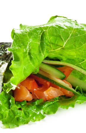 Temaki - Hand Roll Sushi made of Fresh Salmon, Fresh Cucumber, Tomato and Japanese Mayonnaise inside. Nori and Salad Leaf outsideの写真素材