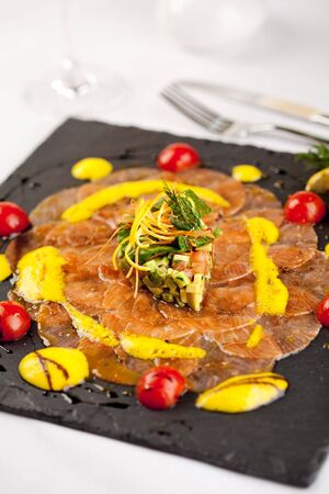 Salmon Carpaccio on Black Dishの写真素材