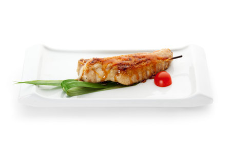 Grilled Chicken Wings Garnished with Cherry Tomato and Green Leaf
