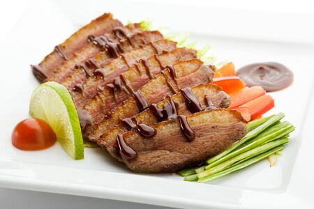 Roasted Breast in Sesame Sauce with Vegetables and Limeの写真素材
