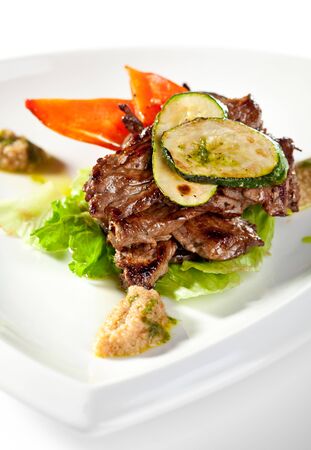 Fried Prime Beef on Salad Leaf Topped with Zucchiniの写真素材
