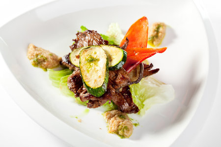 Fried Prime Beef on Salad Leaf Topped with Zucchiniの写真素材