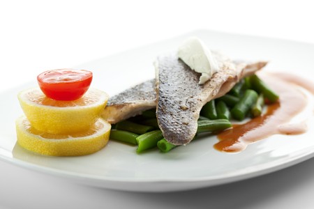 Steamed Fish with Sauce, Lemon and Cherry Tomatoの写真素材