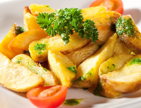 Deep Fried Potato Slice Garnished with Cherry Tomato and Parsley
