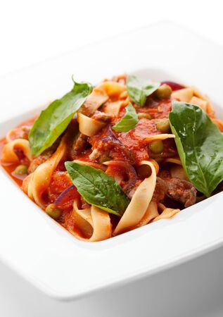 Pasta with Meat, Tomato Sauce and Basil Leafの写真素材
