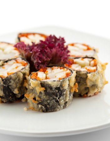 Japanese Cuisine - Deep-fried Sushi Roll with Scallop and Apple Slice, Flying Fish Roe inside. Served with Salad Leafの写真素材