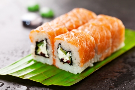 Freshness Roll with Cream Cheese, Cucumber and Salmon Roe inside. Salmon topped. Served on Banana Leafの写真素材