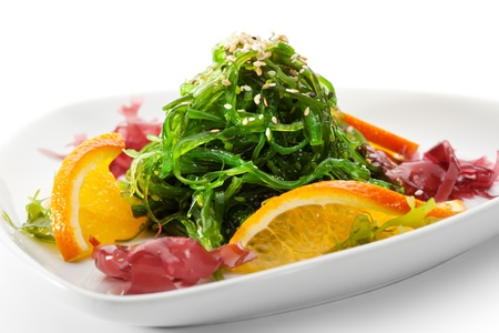 Japanese Cuisine - Chuka Seaweed Salad with Nuts Sauce. Served with Orange and Sesameの写真素材