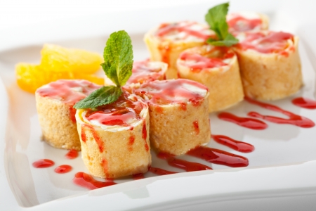 Dessert Maki Sushi - Roll with Various Fruit and Cream Cheese inside. Pancake outside. Served with Strawberries Sauceの写真素材